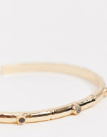 Load image into Gallery viewer, Curve cuff bracelet with bamboo and black stone detail in gold tone
